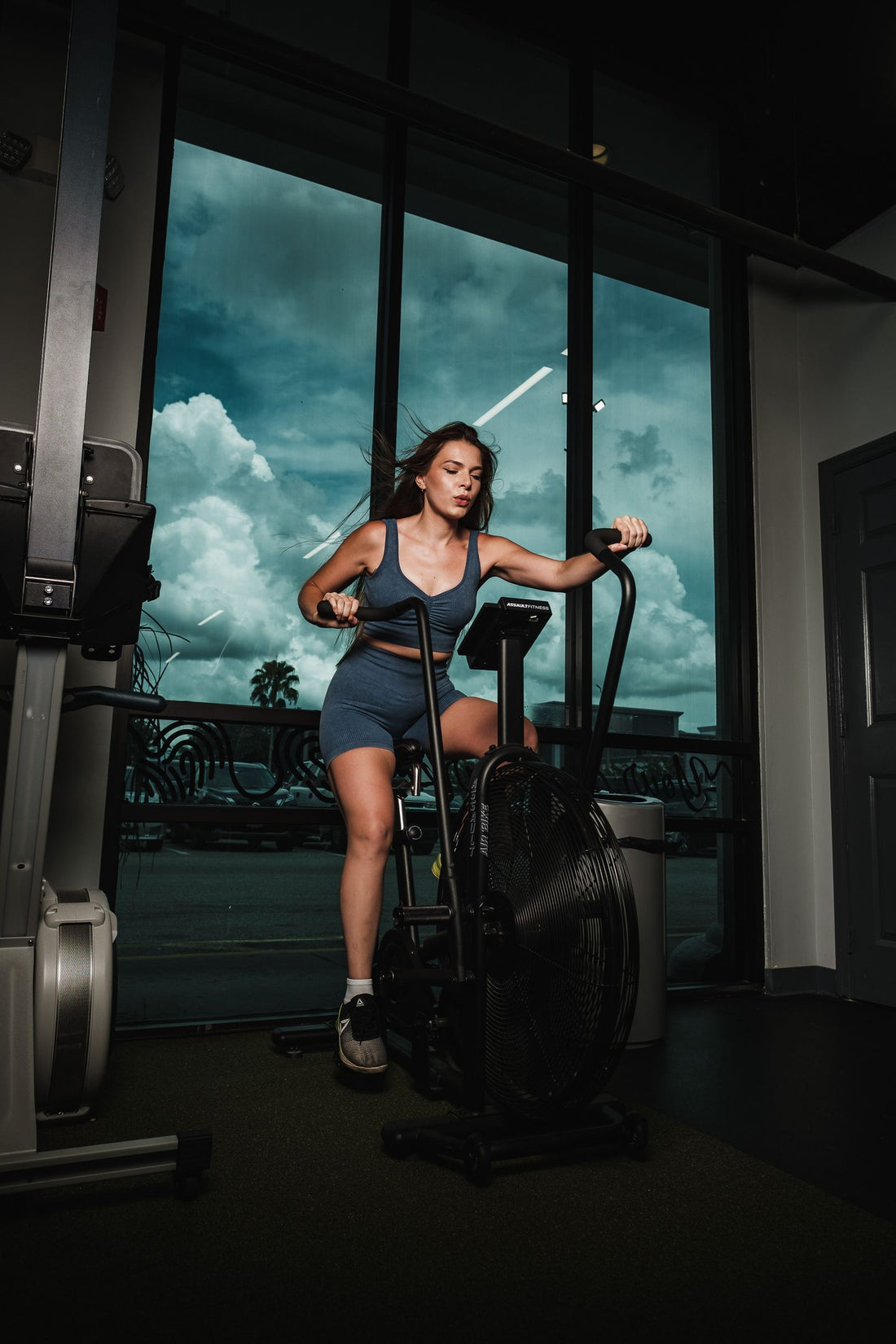 Woman training on a stationary exercise bike indoors, illustrating the best exercise bikes available in South Africa