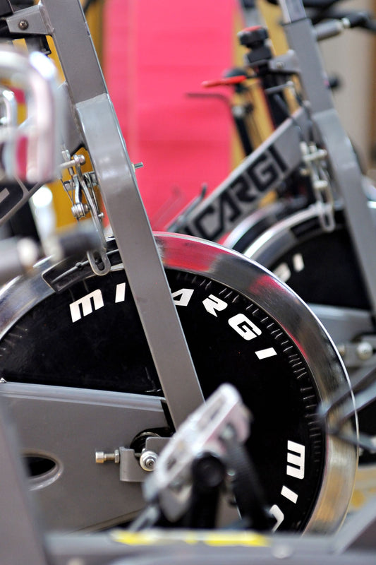 Row of indoor spinning bikes in a fitness studio, illustrating spinning bikes available in South Africa