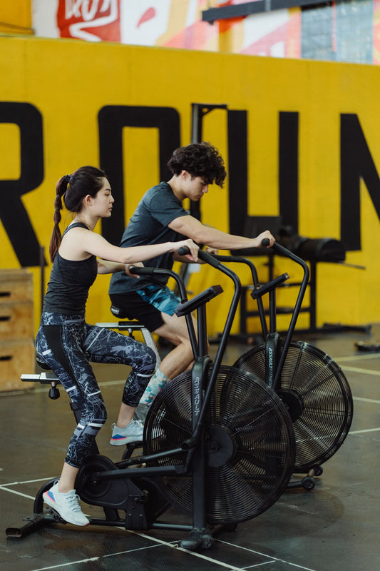 Couple training on affordable stationary exercise bikes at home, illustrating exercise bikes under R10 000 in South Africa