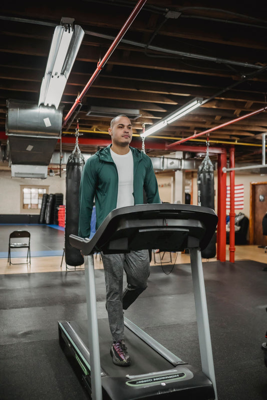 Athlete sprinting on a treadmill in a gym, illustrating curved treadmill training available in South Africa